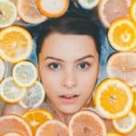woman surrounded by sliced lemons